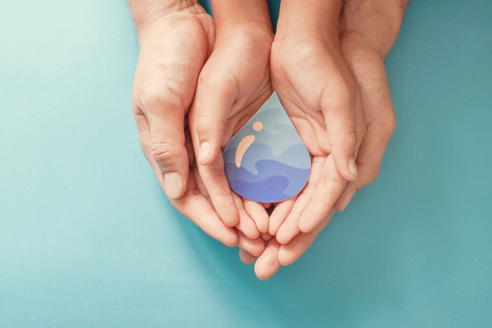 adult child hands holding paper cut water drop world water day clean water sanitation csr save water